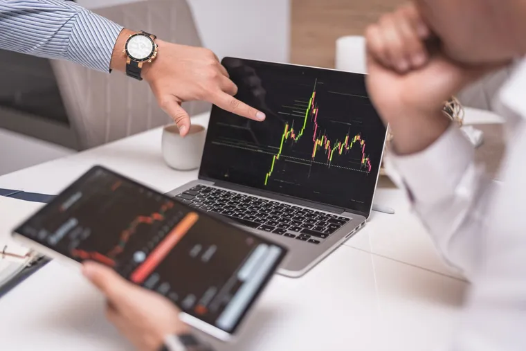 A team analysing data charts on a laptop during an AI opportunity assessment — Avaib