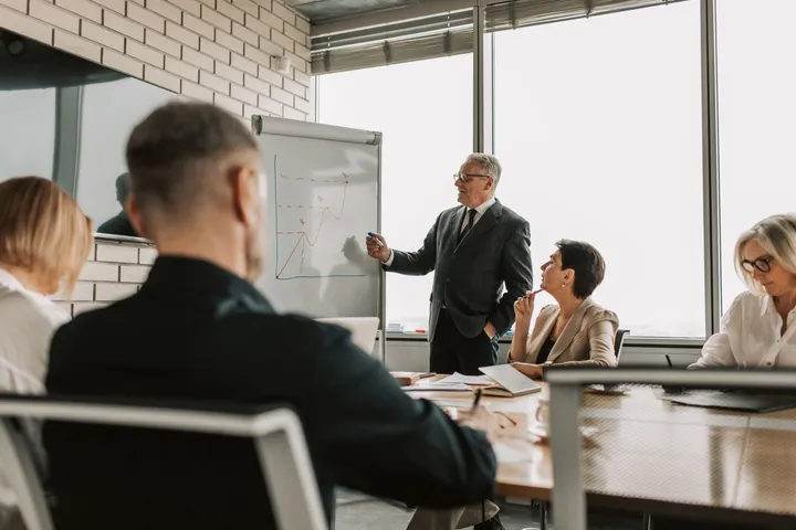 Business consultants planning AI strategy at a whiteboard — Avaib