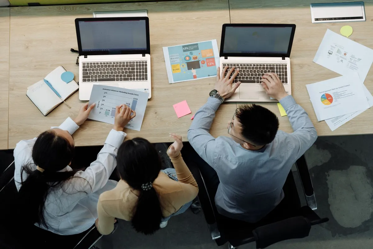 A team reviewing workflow charts together in an office
