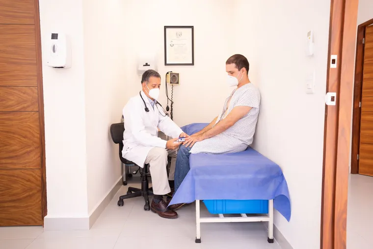 A doctor reviewing notes with a patient in a clinic — Avaib