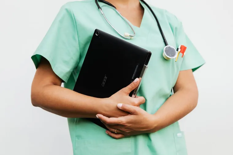 A doctor updating medical records on a tablet — Avaib