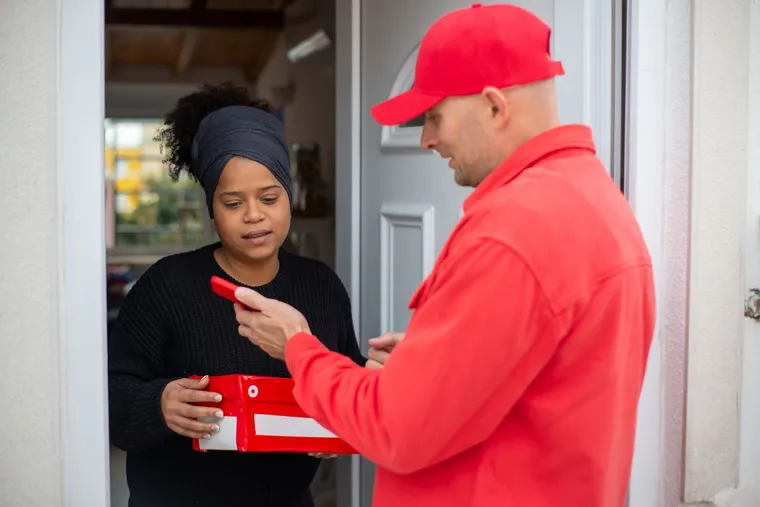 A courier handing a package to a customer — Avaib