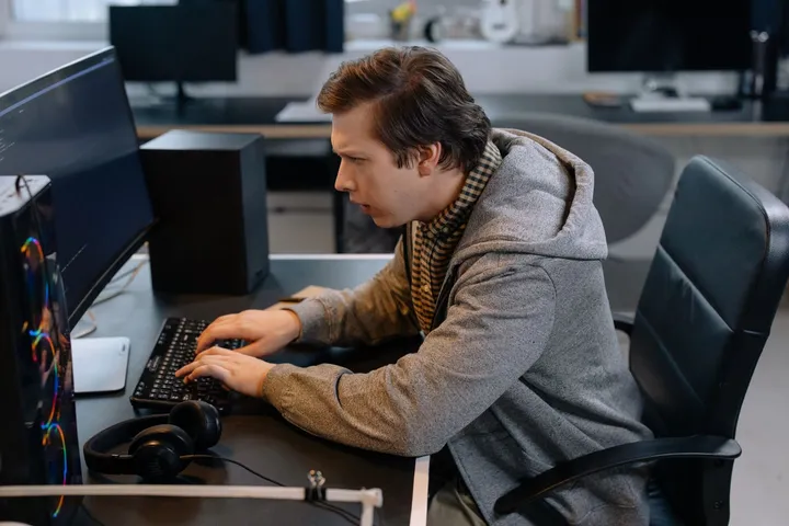 A software developer modernizing an application at their desk — Avaib