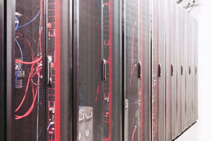 Rows of server racks in a modern data center — Avaib