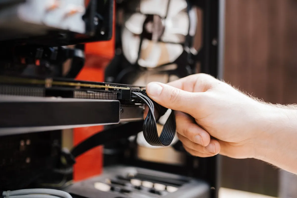 An engineer replacing cables while upgrading old systems