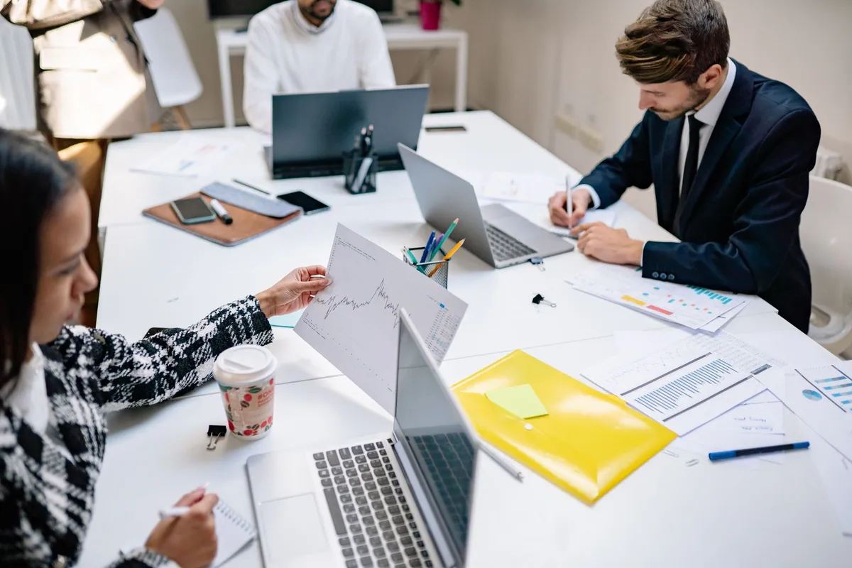 A marketing agency team working on laptops in a modern office