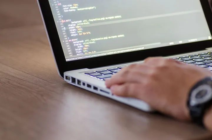 A senior developer reviewing code during scheduled software maintenance — Avaib
