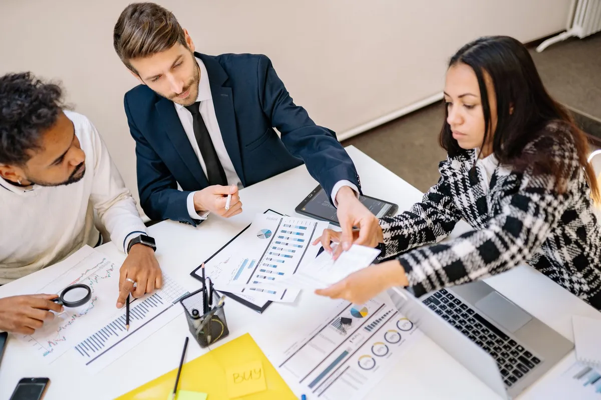 An AI delivery team reviewing model results on a dashboard together