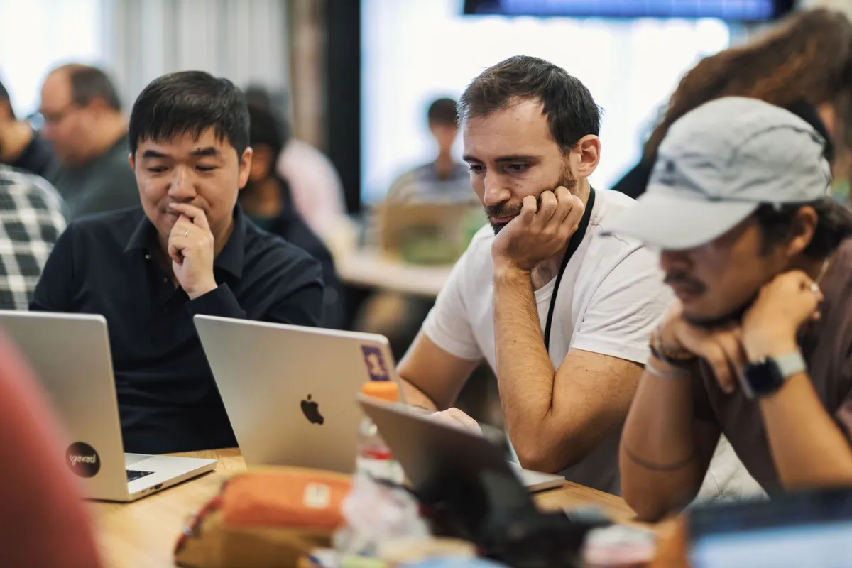 A software development team collaborating across stacks in the office