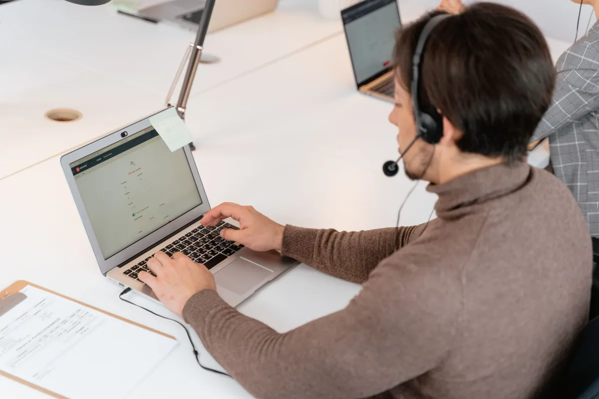 A senior developer building a responsive website on a laptop — Avaib